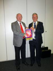 District Governor John Waddell presents President Robert with Rotary banner
